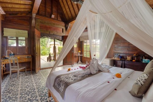 Bed dressed with flower petals in the one-bedroom villa
