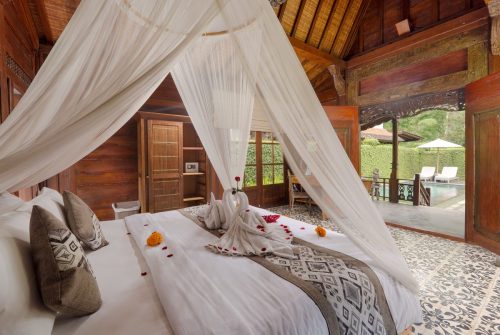 One-bedroom villa bed looking out to the terrace