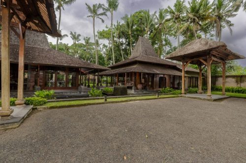 Gravel courtyard and Joglo roofs of Villa Puri Tupai