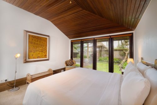 Bright main villa bedroom with framed artwork