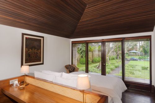 Bedroom with garden view and timber ceiling