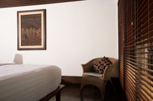 Bedroom corner with rattan armchair