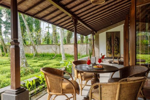 Covered terrace with rattan chairs and welcome drinks