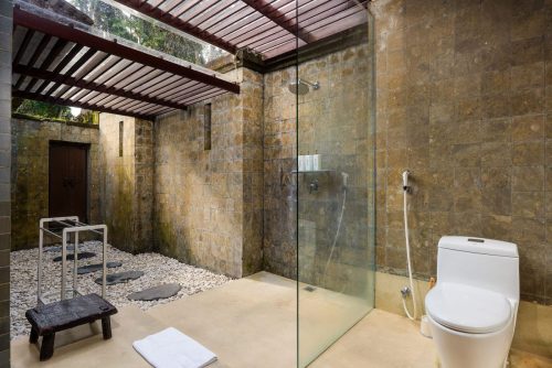 Open-air shower with pebble floor
