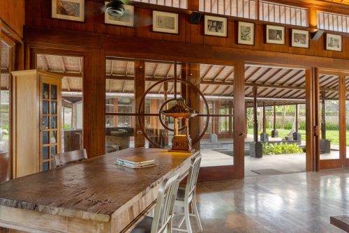 Long timber dining table in the open pavilion
