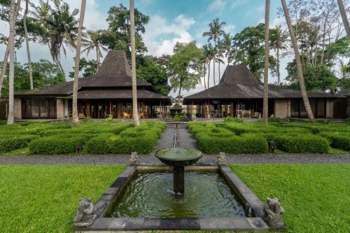 Estate garden with stone fountain and the twin Joglo pavilions
